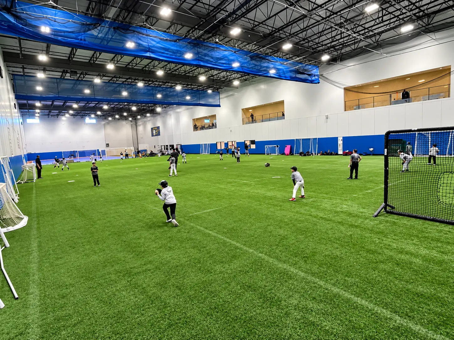 Open indoor turf field during baseball practice