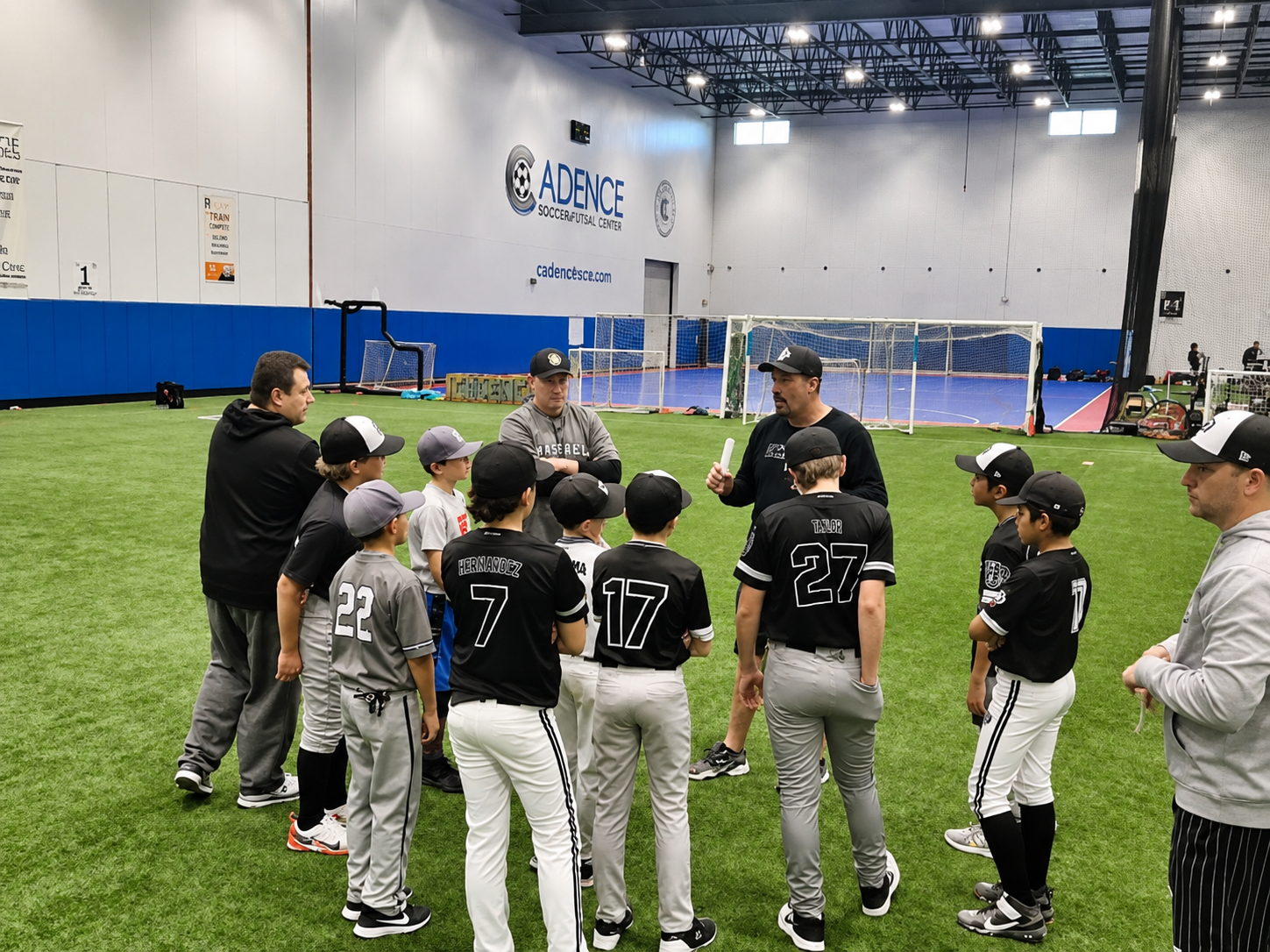 Youth baseball team training on the turf inside Cadence Sports Center